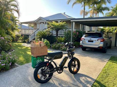 cooly bike electric bike inn driverway out the front of suburban house